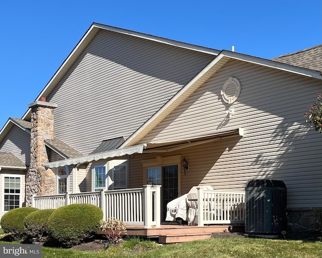 back of property featuring a deck and central air condition unit