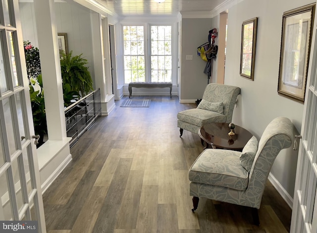 sitting room featuring french doors, ornamental molding, hardwood / wood-style flooring, and a wealth of natural light