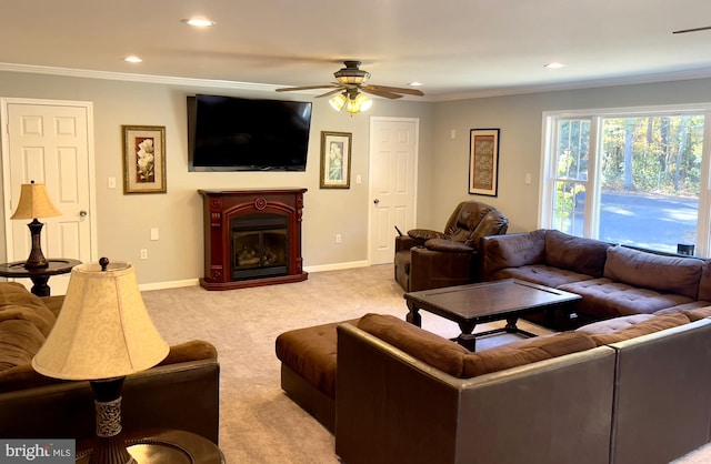 living room with crown molding, light colored carpet, and ceiling fan