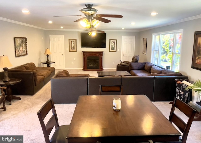 carpeted living room featuring crown molding and ceiling fan