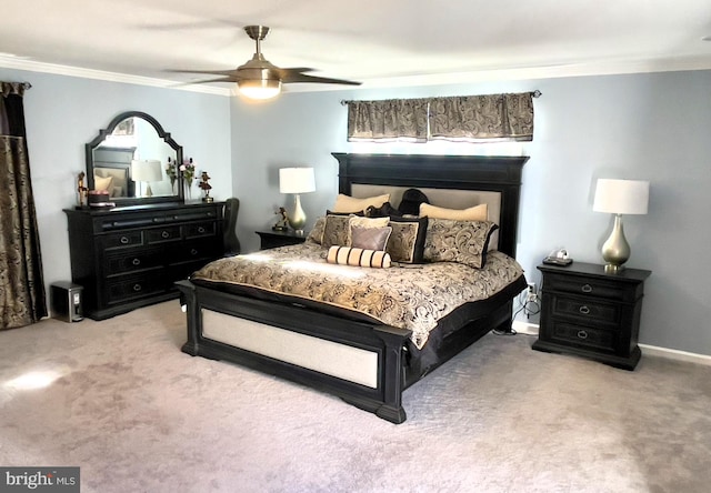 carpeted bedroom featuring crown molding and ceiling fan