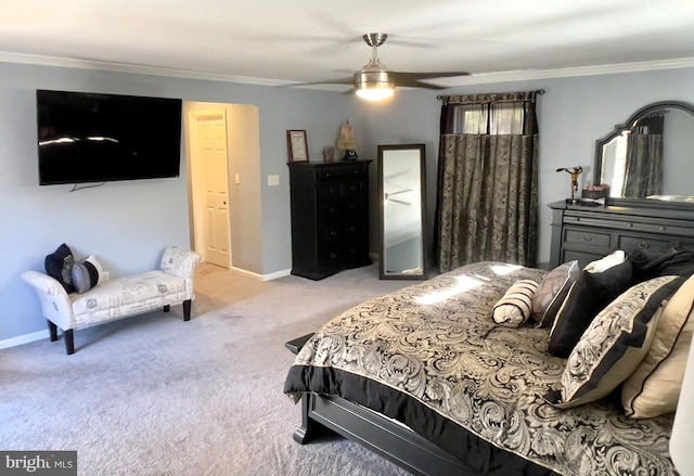 carpeted bedroom with ornamental molding and ceiling fan