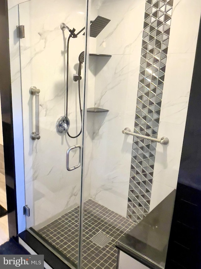 bathroom featuring a shower with shower door