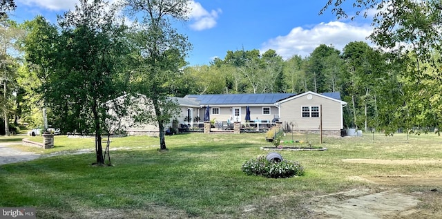 view of front of house with a front yard and a wooden deck