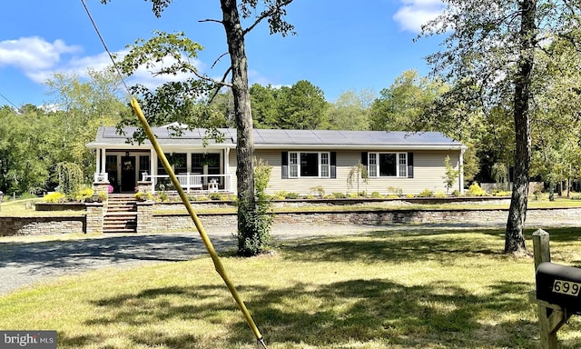 view of front of house with a front yard and a porch