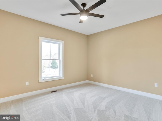 spare room featuring ceiling fan and light colored carpet