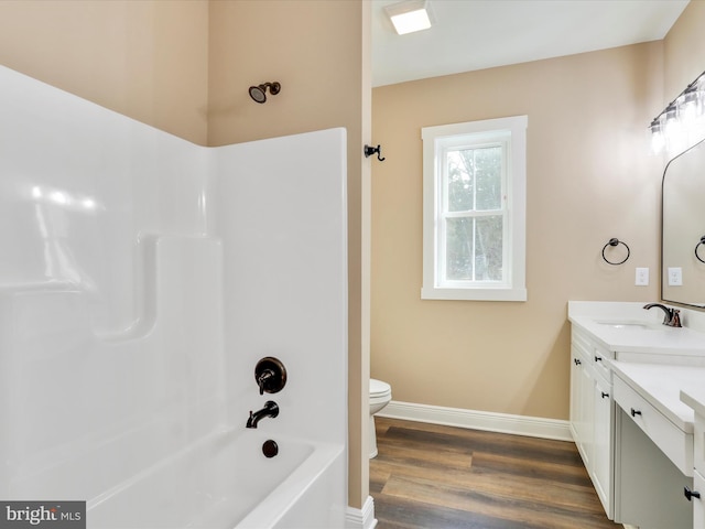 full bathroom featuring toilet, vanity, shower / bath combination, and hardwood / wood-style flooring