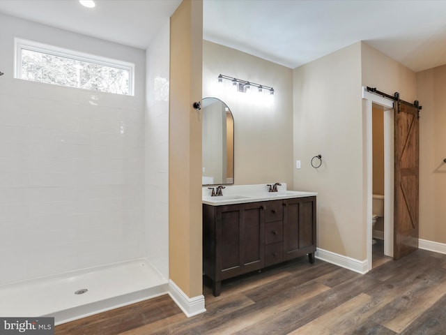 bathroom with vanity, hardwood / wood-style flooring, and toilet