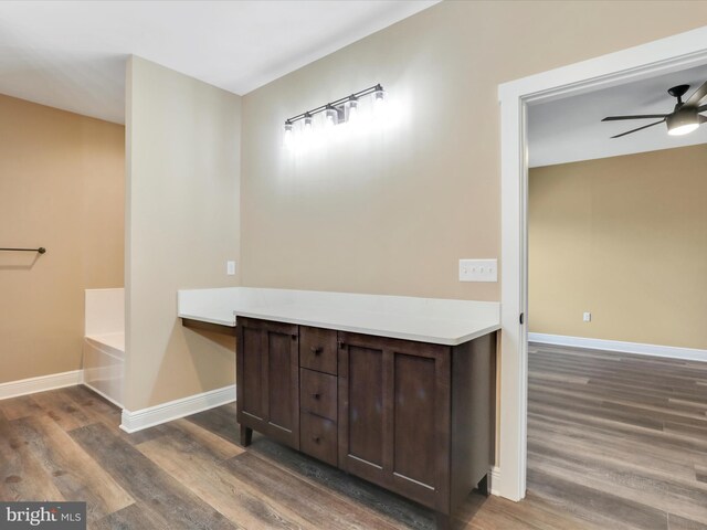 bathroom featuring wood-type flooring, a tub to relax in, and ceiling fan