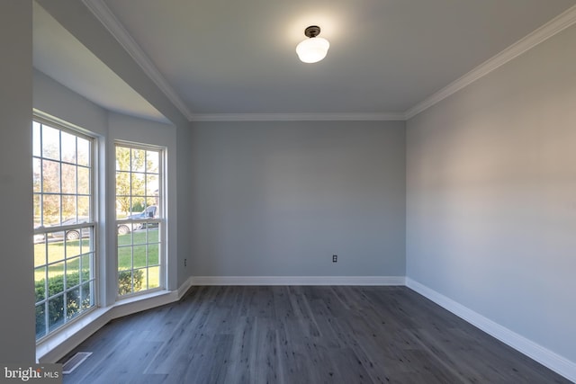 empty room featuring crown molding and dark hardwood / wood-style flooring