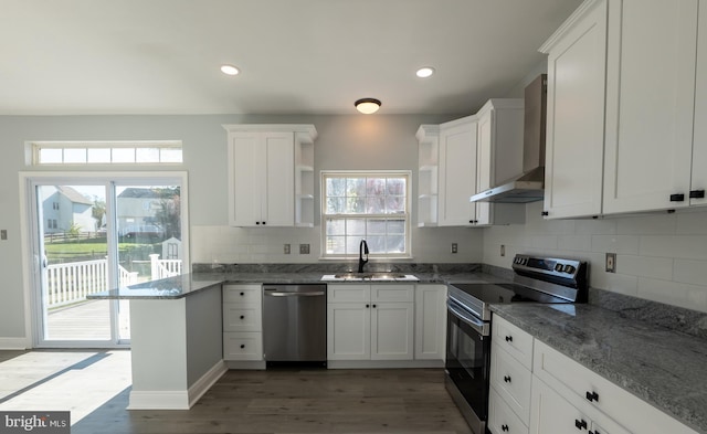 kitchen featuring a wealth of natural light, appliances with stainless steel finishes, and white cabinetry