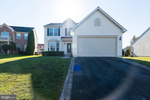 view of front of property with a garage and a front lawn