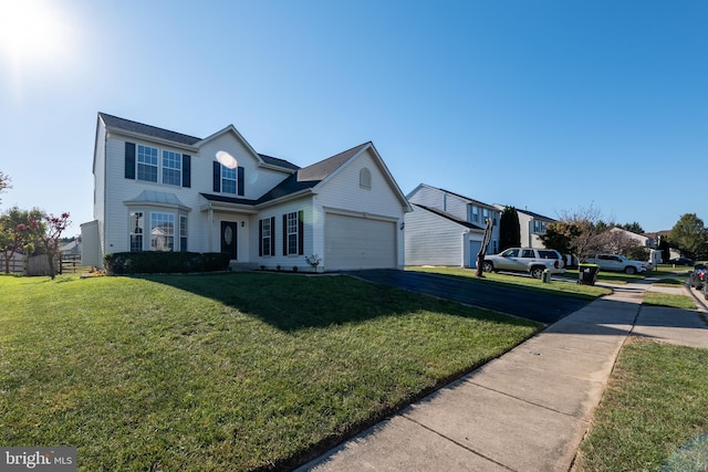 view of property featuring a front lawn and a garage