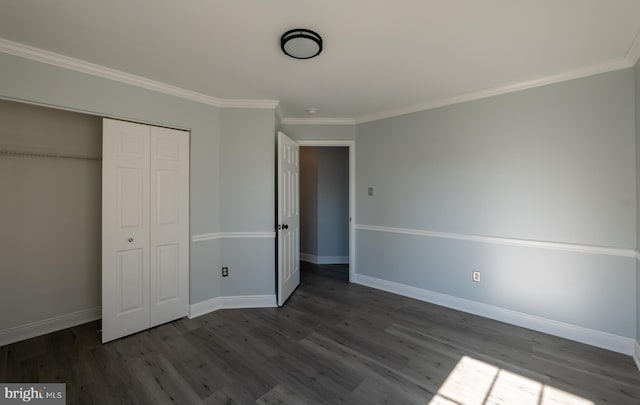 unfurnished bedroom with a closet, wood-type flooring, and crown molding