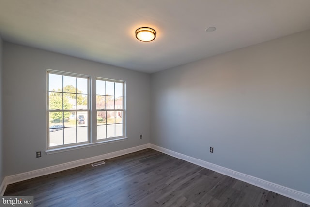 empty room featuring dark hardwood / wood-style flooring