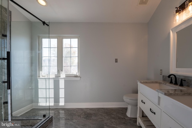 bathroom featuring vanity, toilet, and an enclosed shower