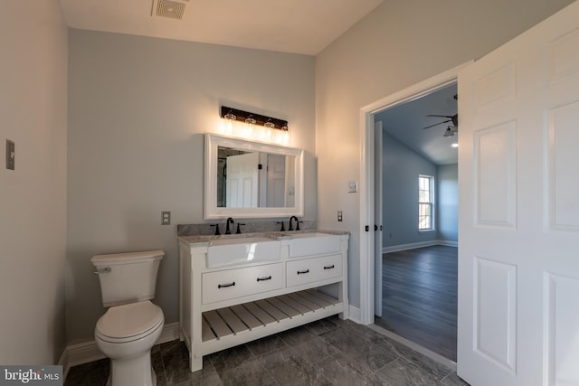 bathroom featuring lofted ceiling, ceiling fan, hardwood / wood-style flooring, toilet, and vanity