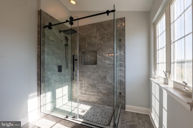 bathroom featuring a shower with door and vaulted ceiling