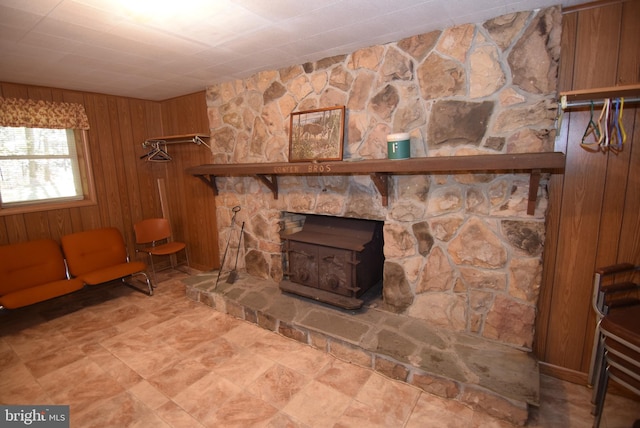 interior details with a wood stove and wooden walls