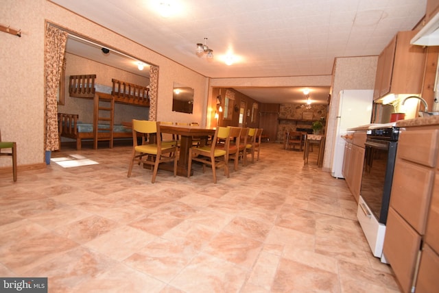 dining space with a stone fireplace