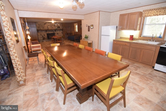 dining room featuring sink and a fireplace