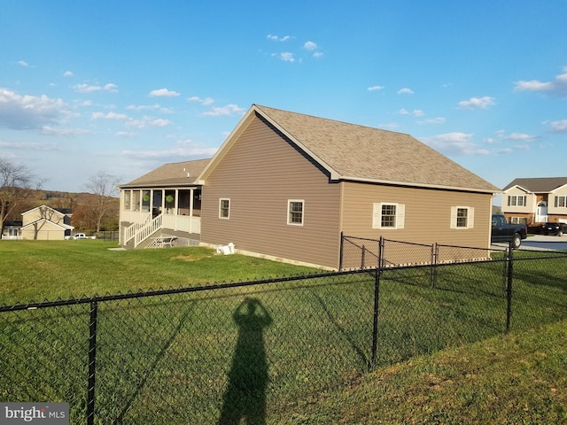 view of side of home featuring a sunroom and a yard