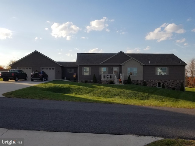 ranch-style home with a garage and a front yard