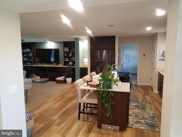 living room with light hardwood / wood-style floors and sink