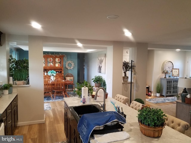 dining area featuring light wood-type flooring and sink