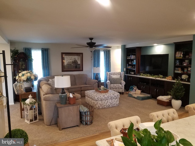 living room with ceiling fan and light wood-type flooring