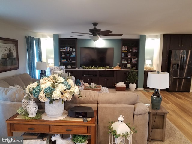 living room with ceiling fan and light hardwood / wood-style floors