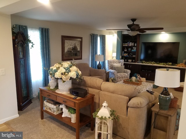 living room with ceiling fan and light colored carpet