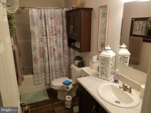 full bathroom featuring toilet, hardwood / wood-style floors, vanity, and shower / tub combo with curtain