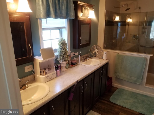 bathroom featuring hardwood / wood-style flooring, vanity, and a shower with door