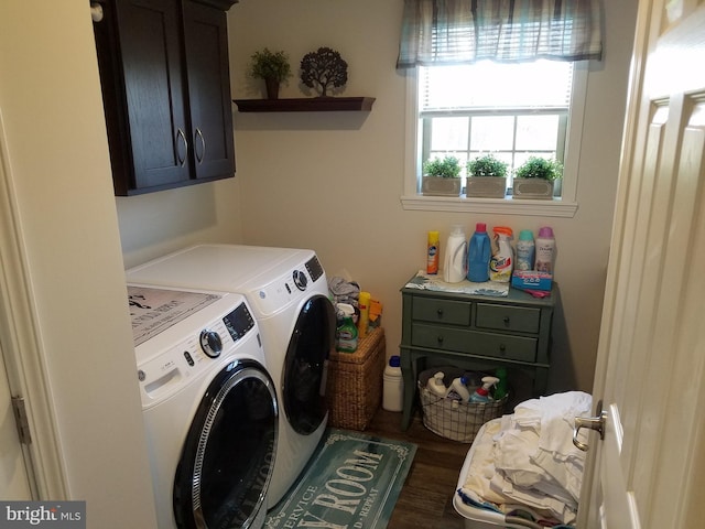 clothes washing area featuring washing machine and dryer, dark hardwood / wood-style flooring, and cabinets