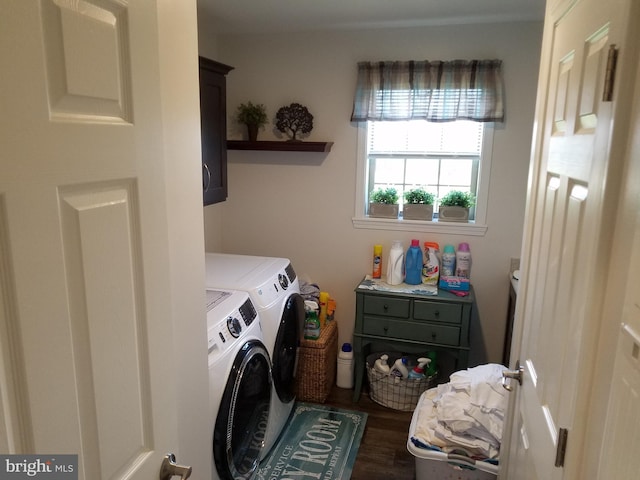 laundry area featuring washing machine and clothes dryer, cabinets, and dark wood-type flooring