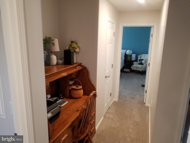 hallway featuring light colored carpet