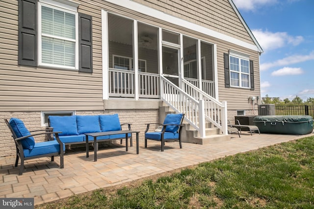 view of patio / terrace with outdoor lounge area and a sunroom