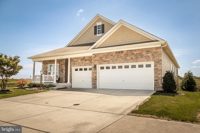 view of front of house with covered porch, a front lawn, and a garage