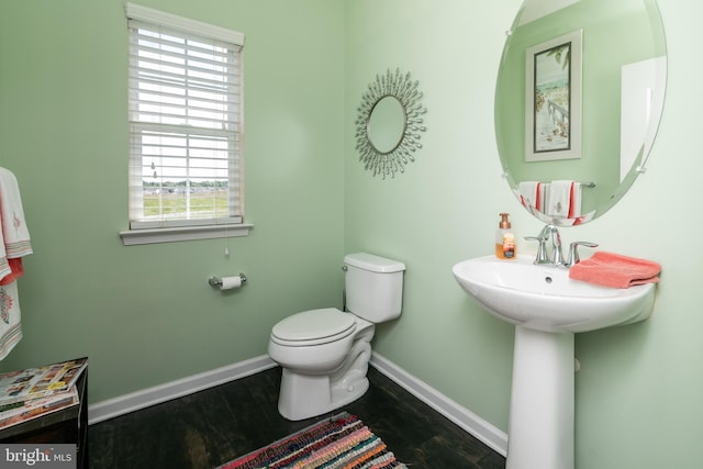 bathroom featuring hardwood / wood-style flooring and toilet