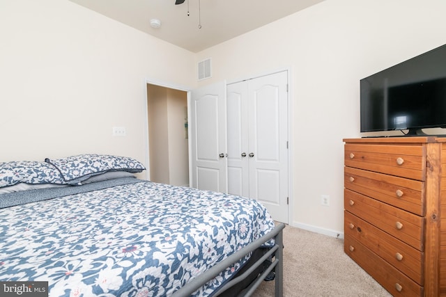 carpeted bedroom with a closet and ceiling fan