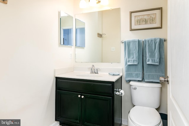 bathroom with toilet and vanity