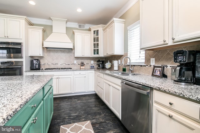 kitchen featuring backsplash, ornamental molding, sink, custom exhaust hood, and appliances with stainless steel finishes