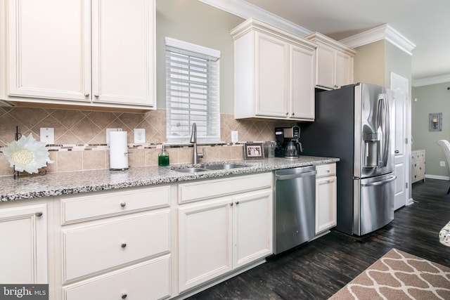 kitchen featuring dark hardwood / wood-style floors, crown molding, sink, appliances with stainless steel finishes, and light stone counters