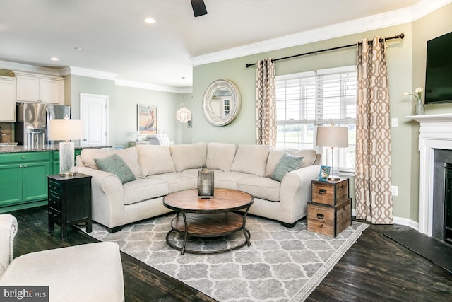 living room featuring sink, ceiling fan, wood-type flooring, and ornamental molding