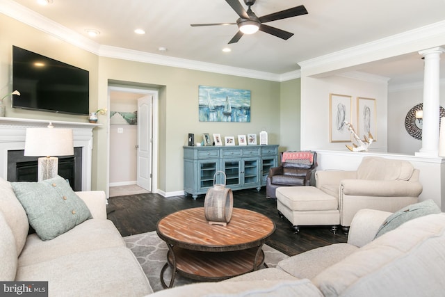 living room with crown molding, dark wood-type flooring, ornate columns, and ceiling fan