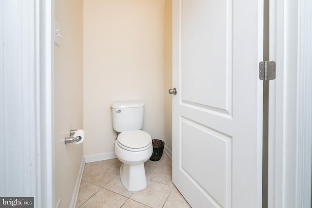 bathroom with toilet and tile patterned floors