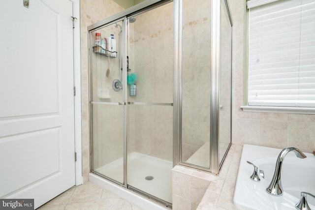 bathroom featuring tile walls, tile patterned floors, and separate shower and tub