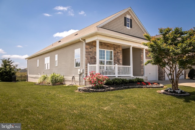 view of front of property with a garage, a front lawn, and a porch