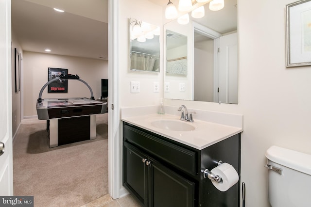 bathroom featuring toilet and vanity